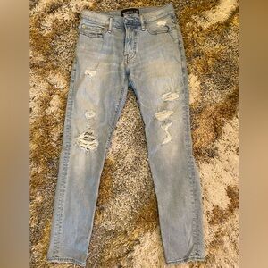 Abercrombie and Fitch, light blue jeans white colored rips. In good condition.